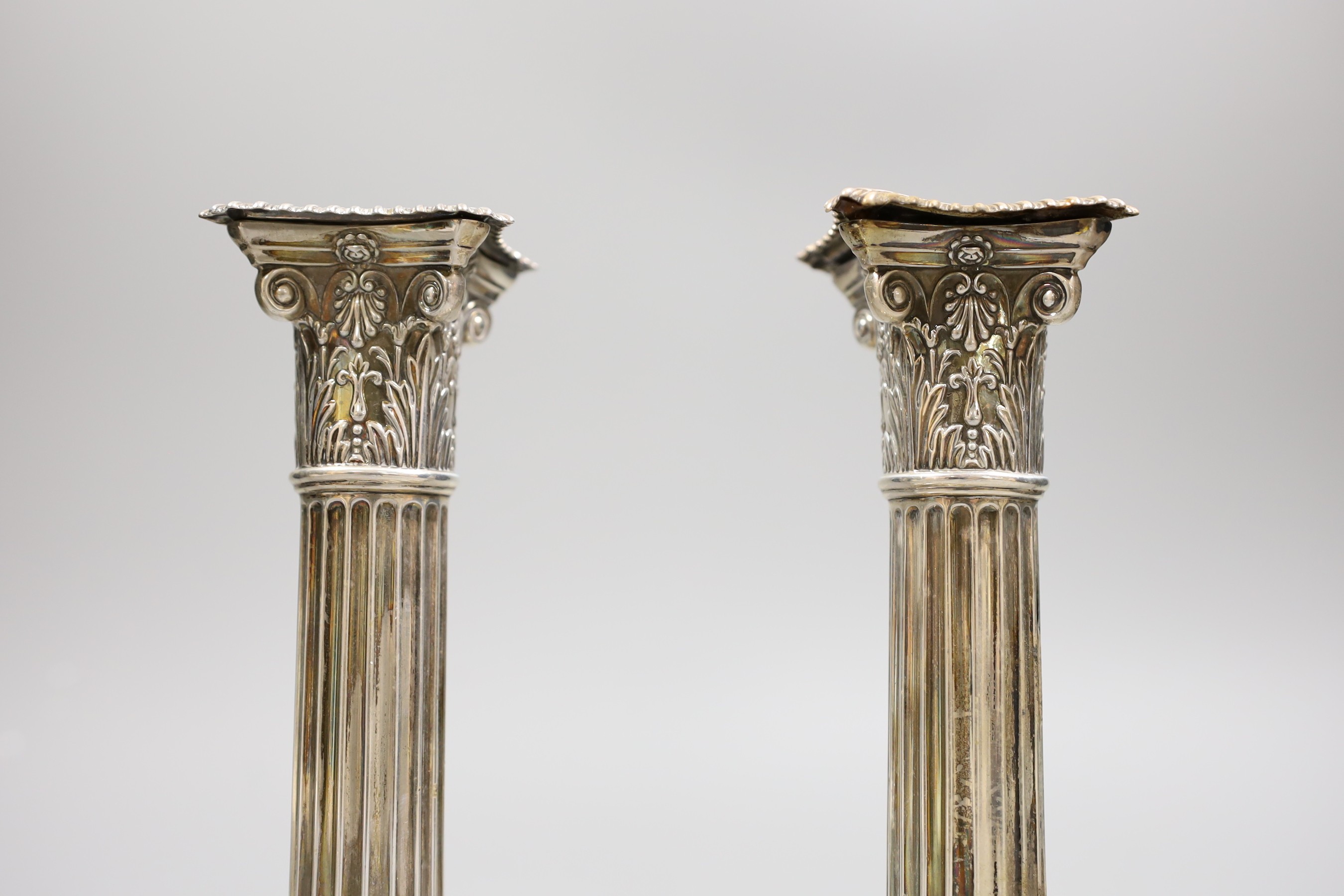 A pair of Edwardian silver Corinthian column candlesticks, Henry Wigful, Sheffield, 1904, height 19.7cm, weighted.